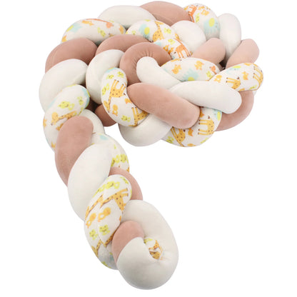 Tour de lit tressé beige et blanc avec motifs girafe, doux et sécurisant pour bébé.